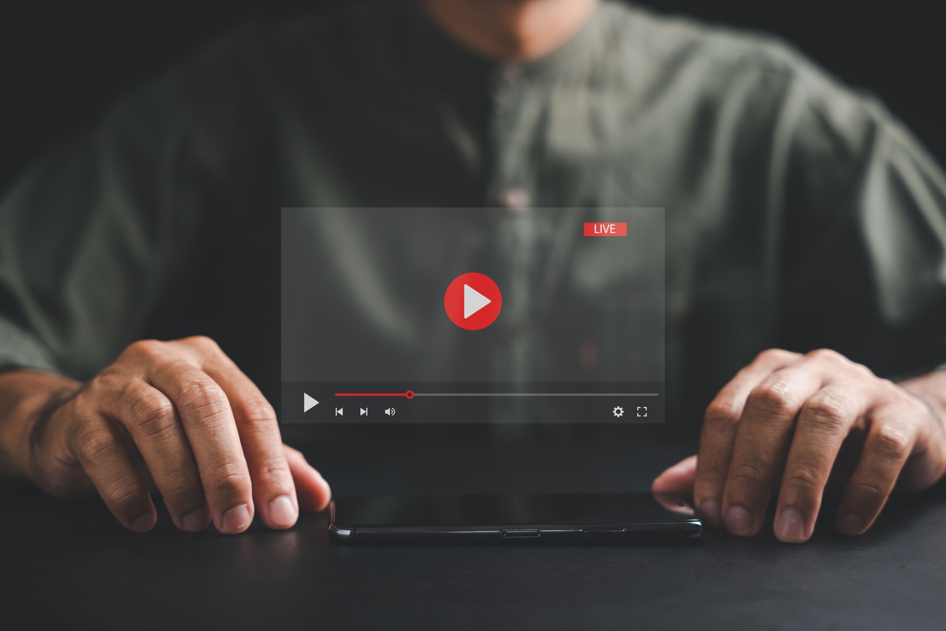 Man enjoying video streaming on virtual screen with a smartphone