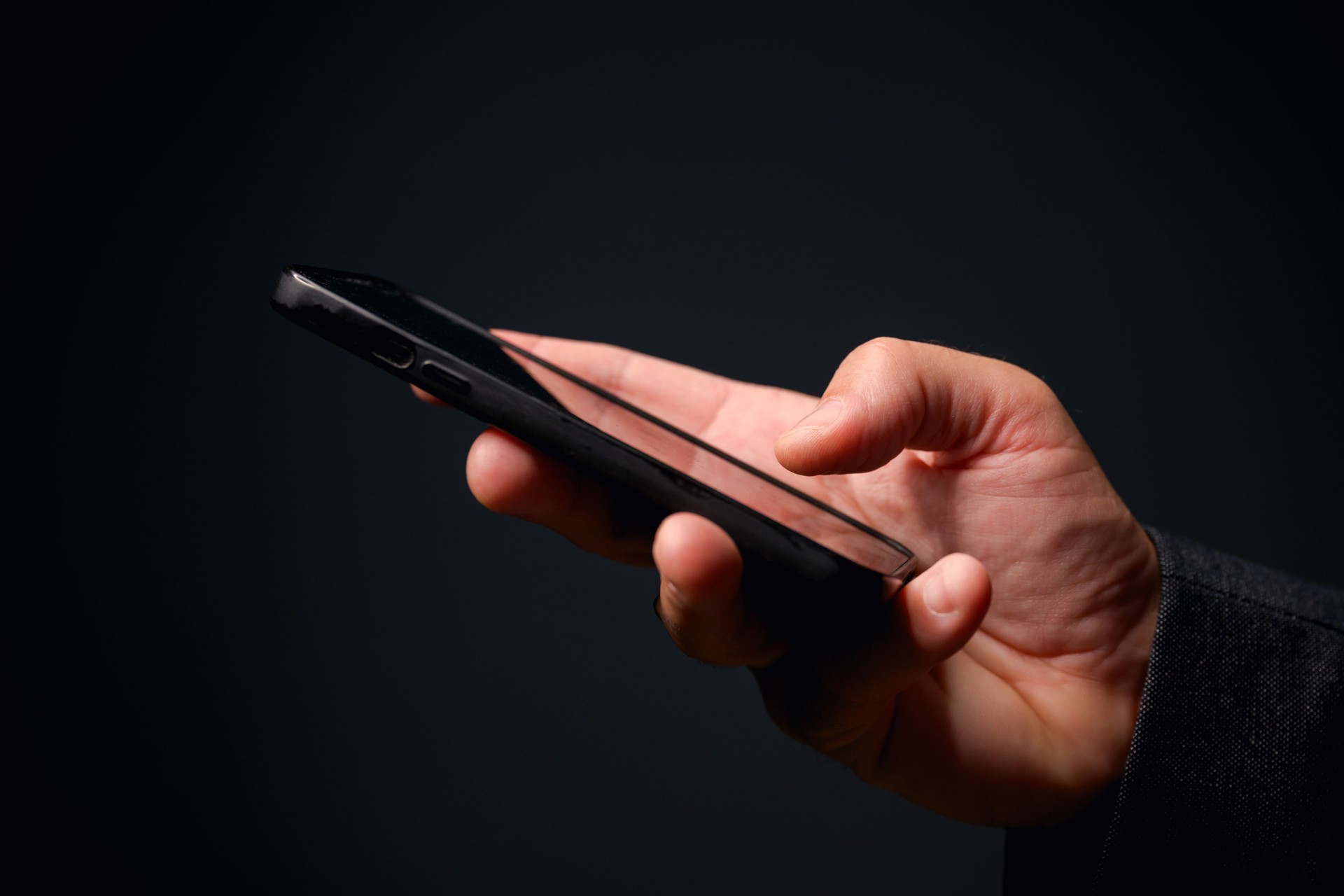 Closeup of male hand with smartphone, businessman using mobile phone for communication